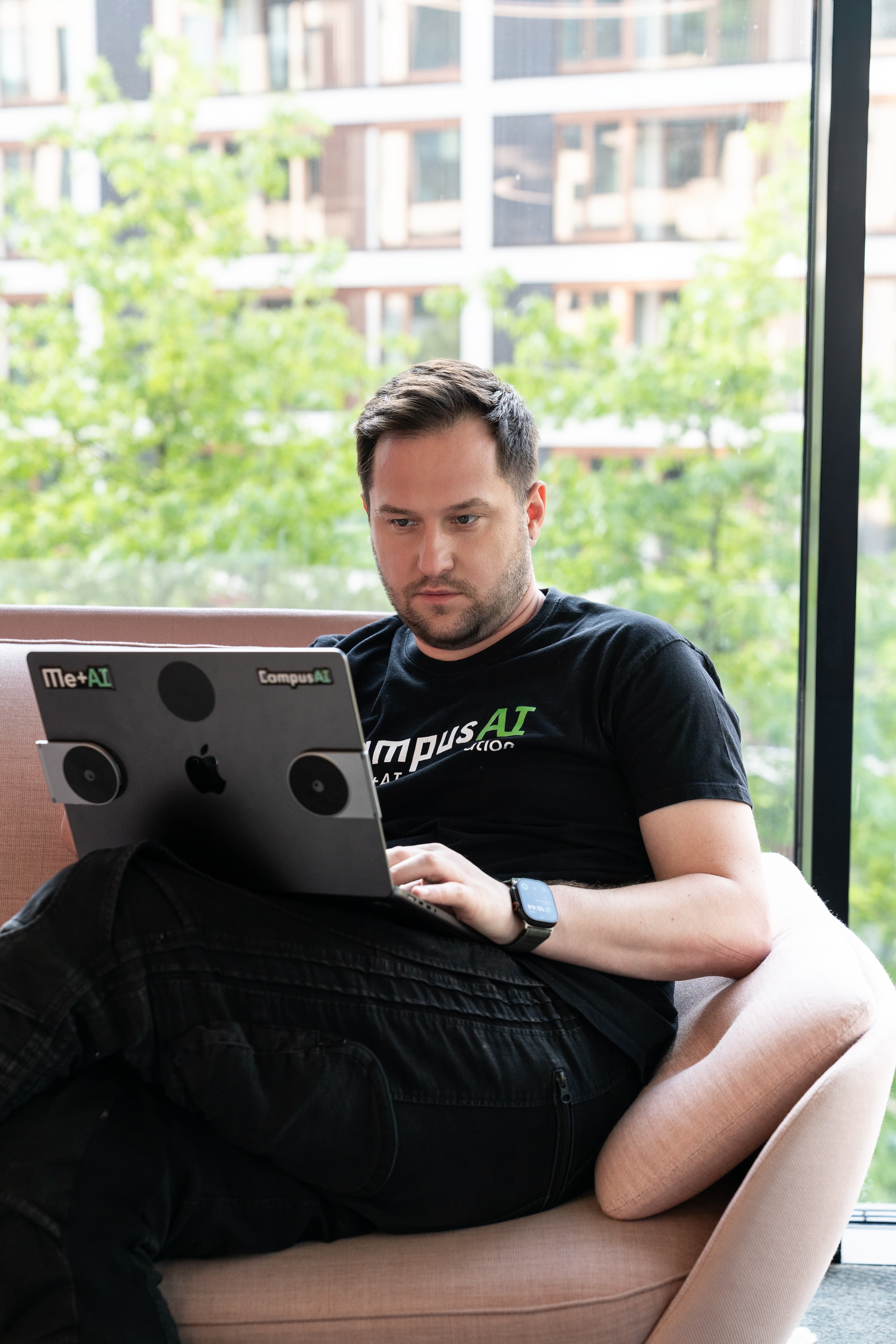 Aureliusz Górski working on his laptop in an armchair
